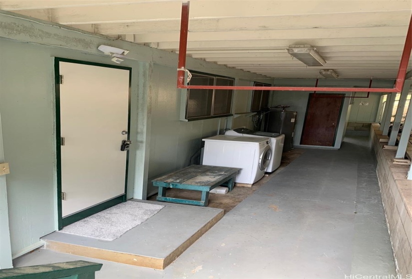 Covered patio with newer washer and dryer.