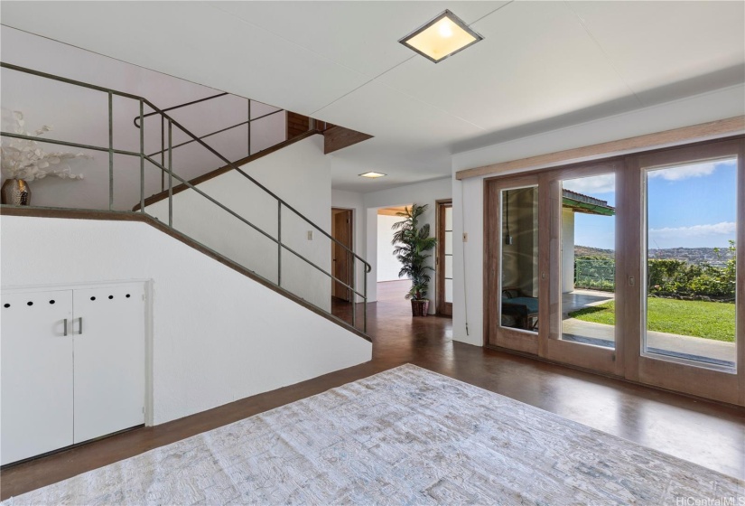 Between the kitchen + wide stairs, is a large open Dining room with beautiful front yard, Diamond Head & city lights views,