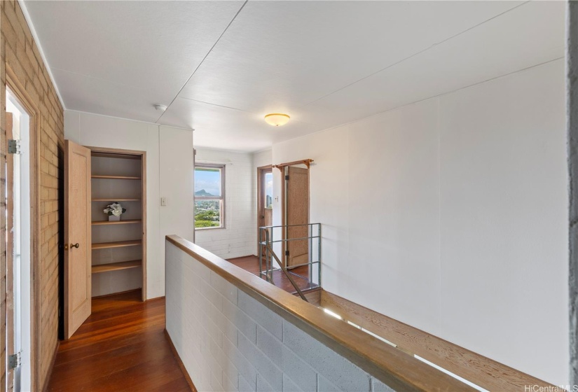 Upstairs on the right are 2 guest bedrooms, with Primary bedroom on the Left, and also a hallway to laundry room and backyard terraced garden.