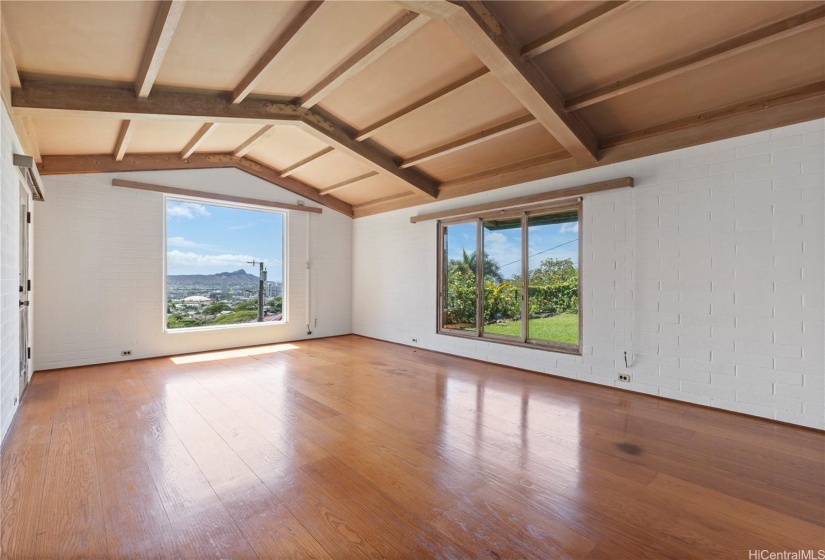 XXL Livingroom with tall ceilings and big window views of Diamond head, Manoa, ocean and the lovely front yard. Also door to the ADU trolley to the sidewalk/garage