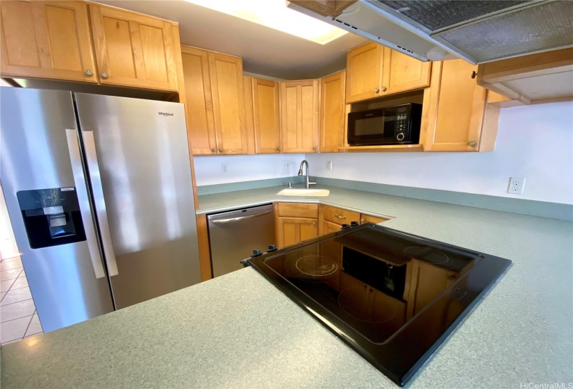 kitchen with flat top stove and stainless appliances