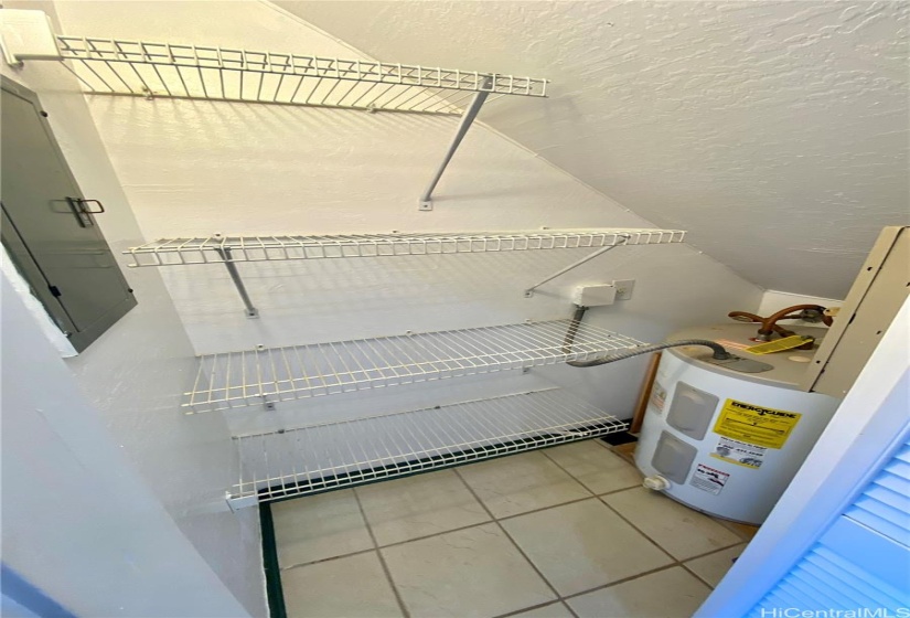 storage closet next to kitchen with water heater