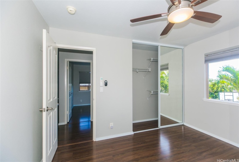 upstairs bedroom with spit ac & ceiling fan