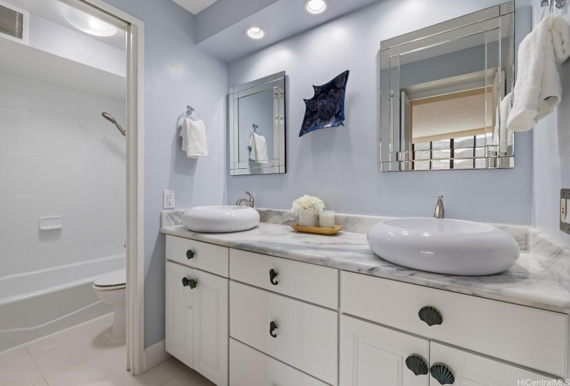 Primary en-suite bathroom has double vanities...and the bathtub was just re-glazed.