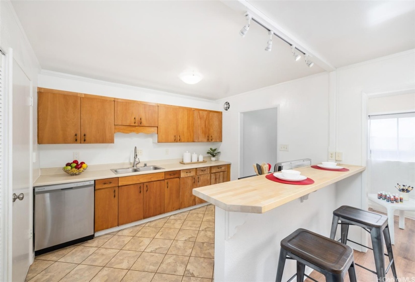 Kitchen with newer appliances, tract lighting and breakfast bar