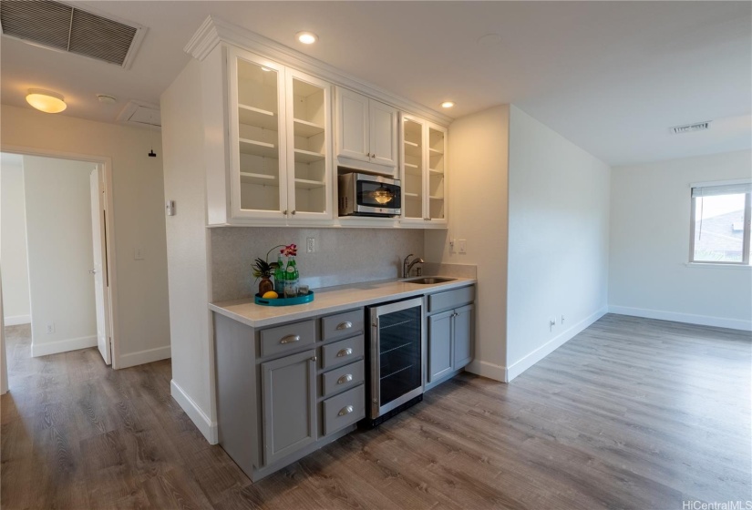 There is a bar with a wine refrigerator off the family/media room upstairs.