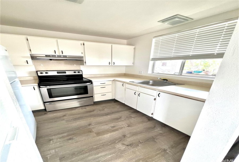 Newer flooring in kitchen.  Clean and bright.