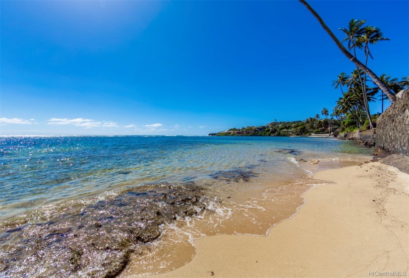 Spectacular shoreline with clear ocean water and partial sandy beach.