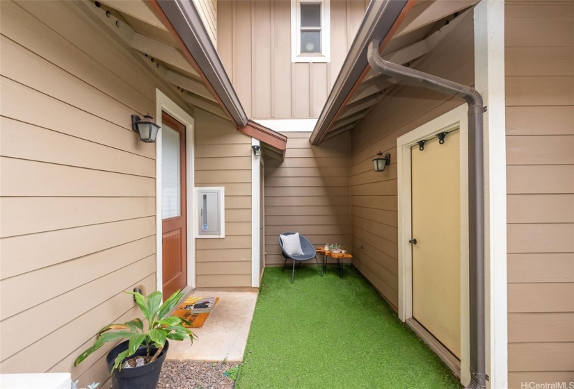 Back courtyard between garage and kitchen door.