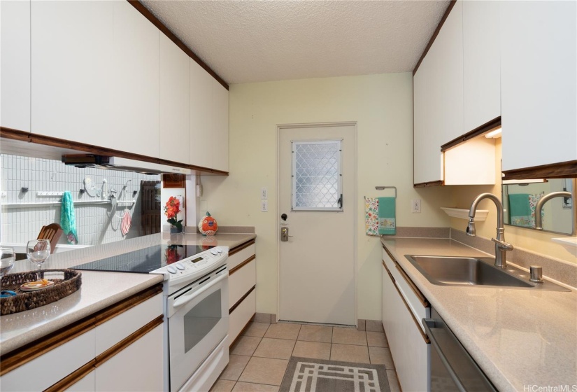 Kitchen has covered entry via a laundry/mud room/storage area, gated and accessed from carport.