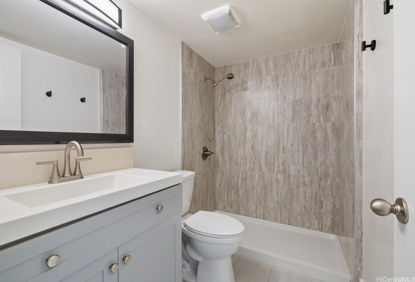 Tastefully renovated bath w/quality materials & large low-entry shower.