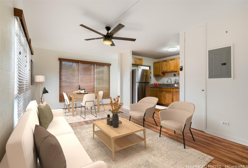 Bright living room with large windows looking towards dinging area and kitchen.  (Enhanced photo)