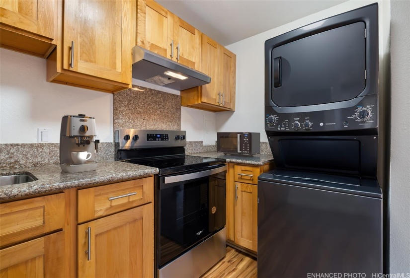 Granite counters and full-size stack washer/dryer for your convenience.  (Enhanced photo)