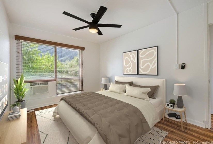 Bright bedroom 2 with large window with green view, ceiling fan and AC.  (Enhanced photo)