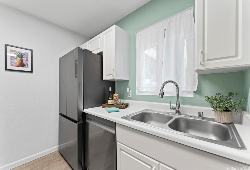 Kitchen with new dishwasher, refrigerator, glass top stove, and microwave