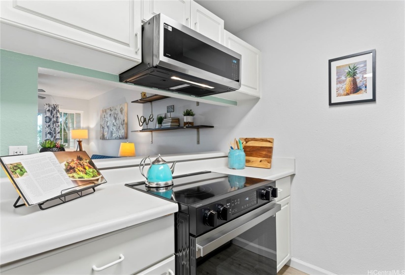 Kitchen with new dishwasher, refrigerator, glass top stove, and microwave