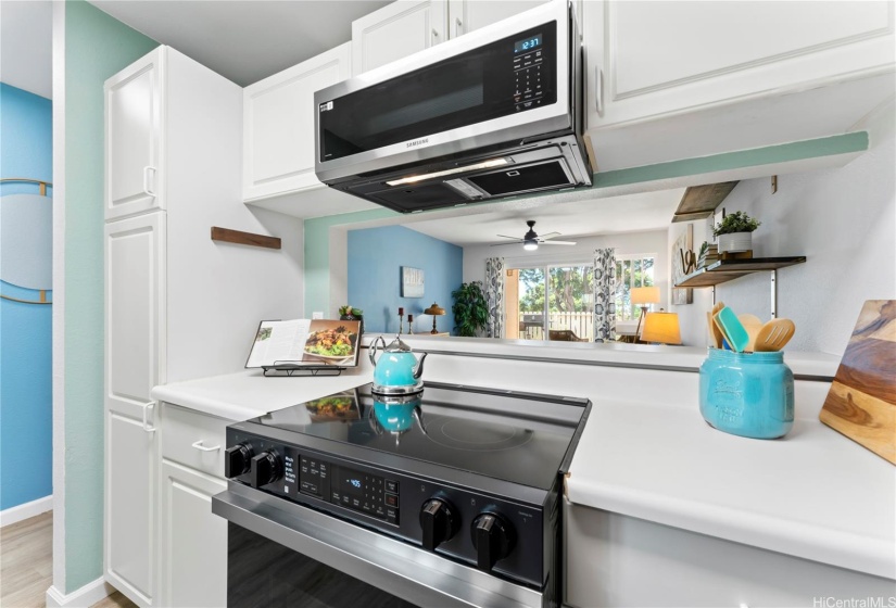 Kitchen with new dishwasher, refrigerator, glass top stove, and microwave