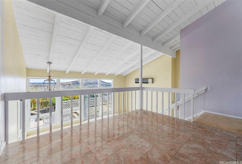 Dining area towards living area downstairs and sliding doors that lead out onto the second lanai