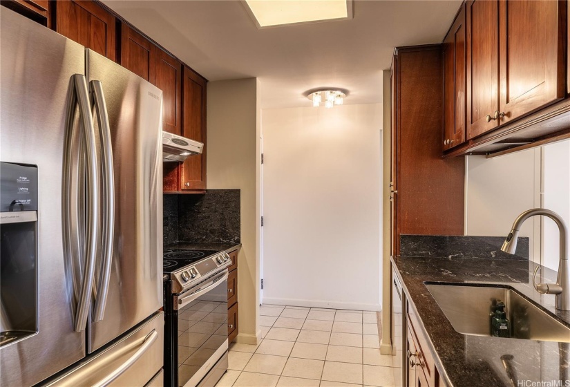 Cabinets, counters, stainless steel appliances all renovated for a modern look