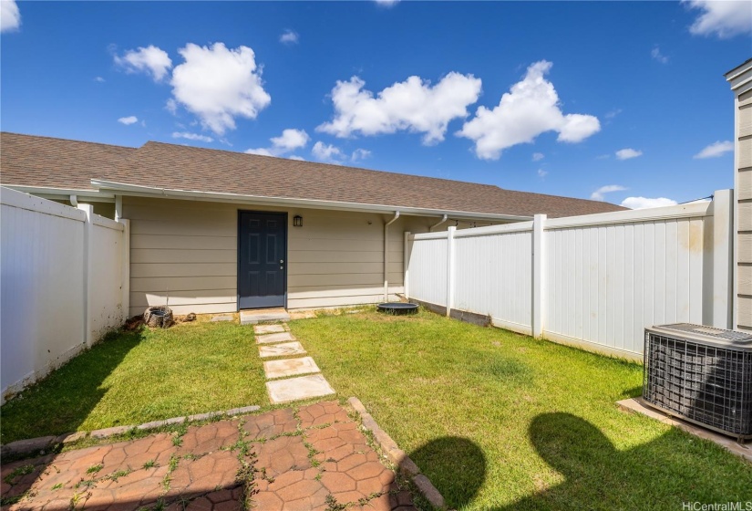 Fenced in backyard inviting you to plan your garden or tropical oasis.