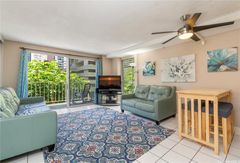 Living room with ceiling fan. Large 1 bedroom with over 600 interior sqft.