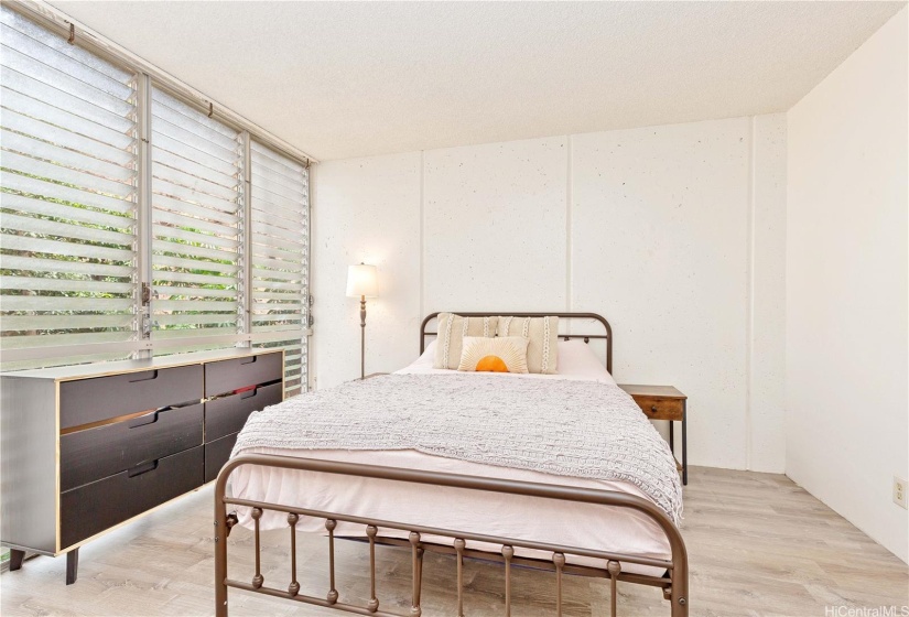 Floor to ceiling windows bring natural light and breeze into the bedroom