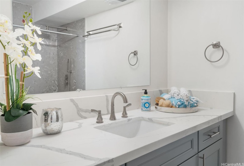 Mauka (mountainside) bathroom, fully remodeled. Bathtub was replaced with a large walk-in shower offering both overhead rainshower and hand-held fixtures.