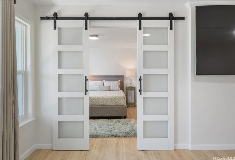 Barn door entry to makai (ocean side) bedroom en suite.