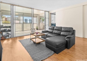 Spacious living room with laminate floors and lots of outdoor light