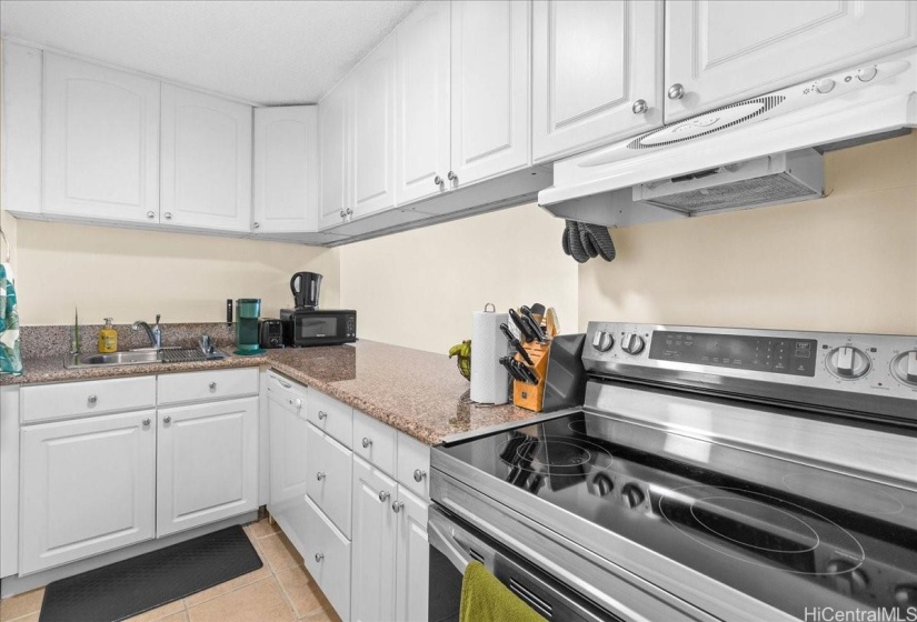 Upgraded kitchen with modern cabinetry and granite counters