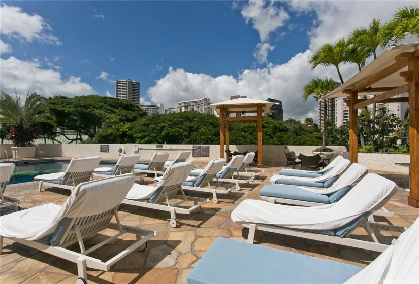 Lounge chairs by the swimming pool.