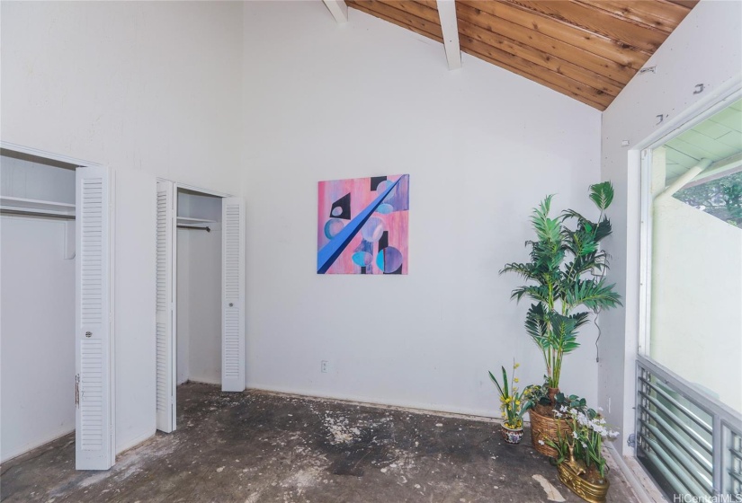 Primary bedroom with its 2 closets has pleasing vaulted ceilings