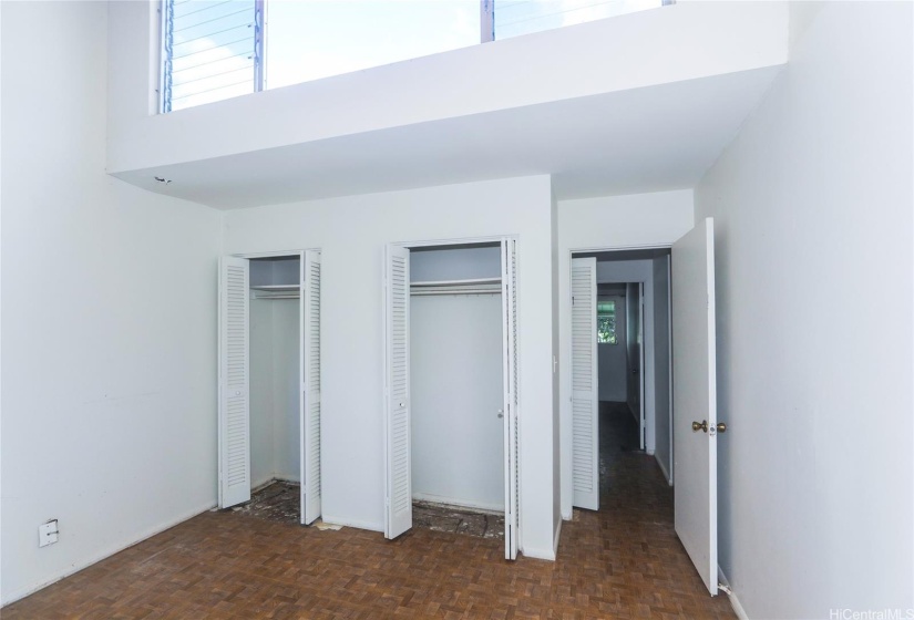 3rd bedroom facing South has a vaulted ceiling with louvered windows  facing North and can also bring in the tradewinds.  All bedrooms have double closets