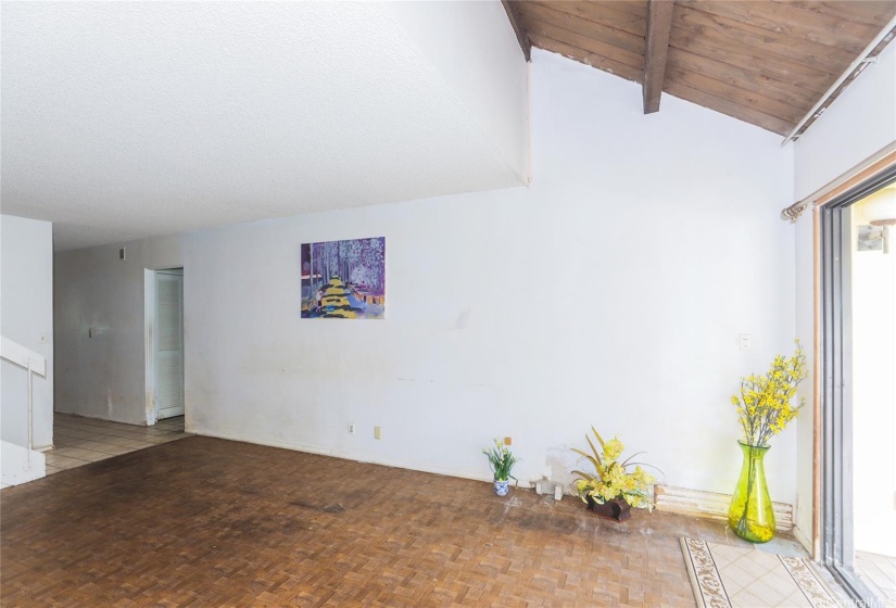 living room with open stairwell has a skylight  for a brighter living area.