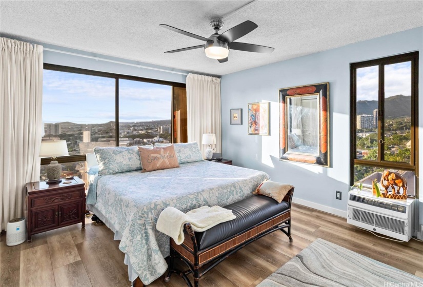 Stunning Primary bedroom takes full advantage of the corner unit location with it's ocean, city, and mountain views.