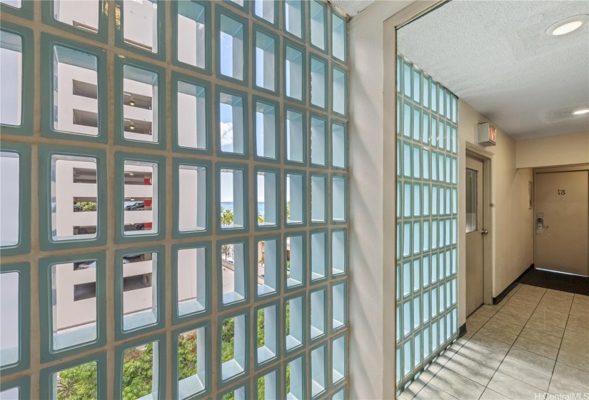 Mid-century modern tile touches bring in the breeze to the elevator hallway.