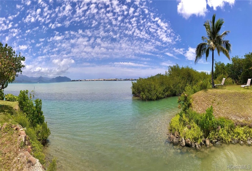 Panoramic view showing the entrance to the shallow draft harbor.  There is a channel even at low tide.  Purplish area can be exposed at low tide.