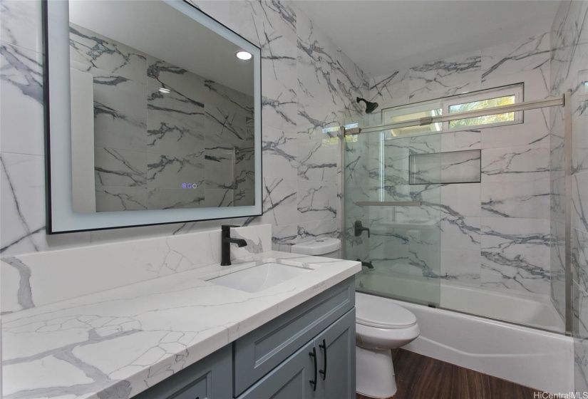 Downstairs bathroom fully renovated with tile surround and LED mirrors