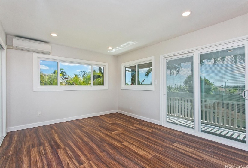 Spacious primary bedroom with sliding door leading to lanai