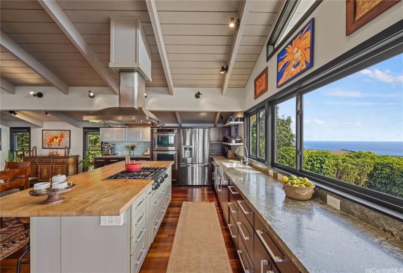 Granite countertops and large island. VIEW of ocean and Diamond Head from kitchen windows