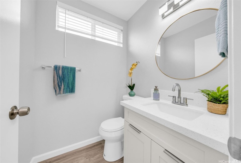 Modern half bath in the main living floor for guests.