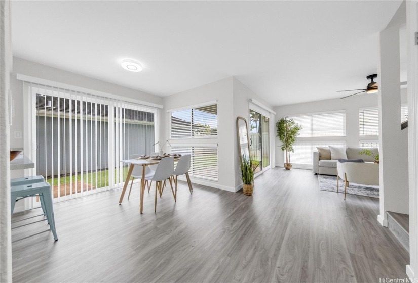 Airy room with two sliding doors to the backyard.