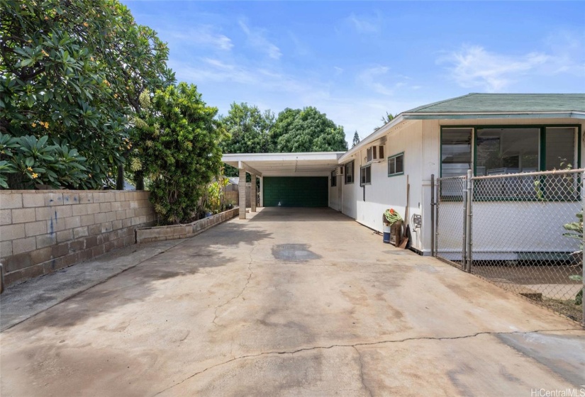 Large drive way carport and full enclsoed garage with storage work rook