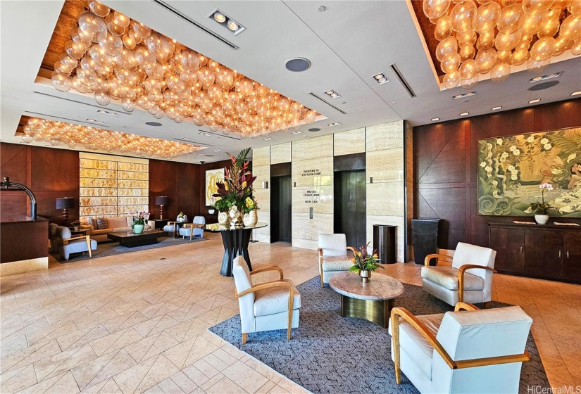 Ground floor lobby right inside the porte-cochere. Two elevator doors straight to the 6th floor hotel lobby.