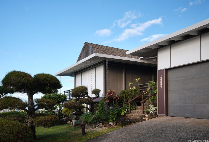 View of the front of the home with mature bonzai trees.