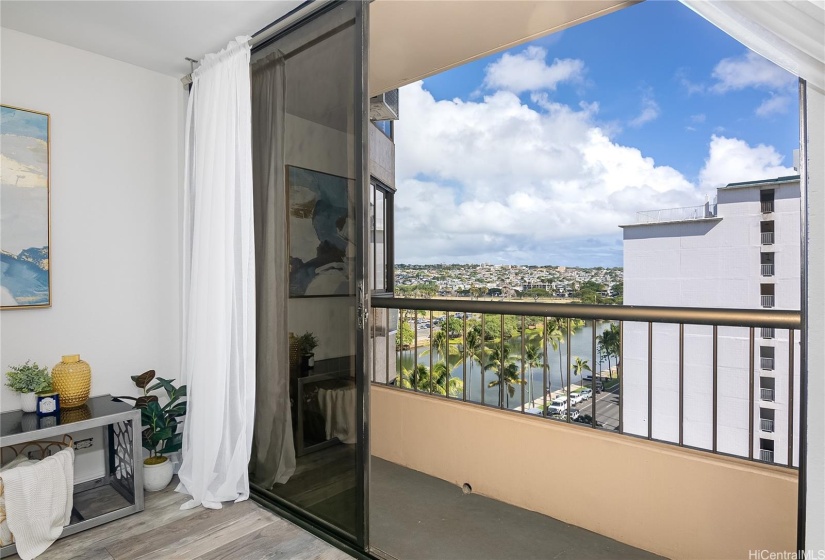 Enjoy these lovely views of the city skyline, lush golf course, and canal, all from the comfort of your living room and private lanai