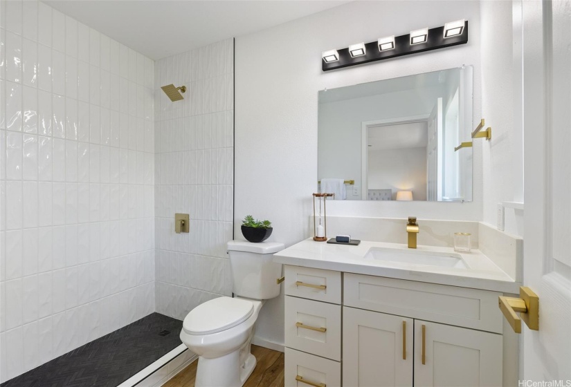 Elegant primary bathroom, shower is tiled all the way to the ceiling!