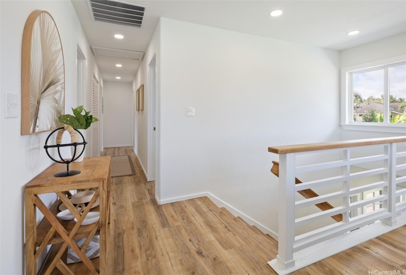 Hallway leading to 3 large bedrooms, home is equipped with an attic fan.