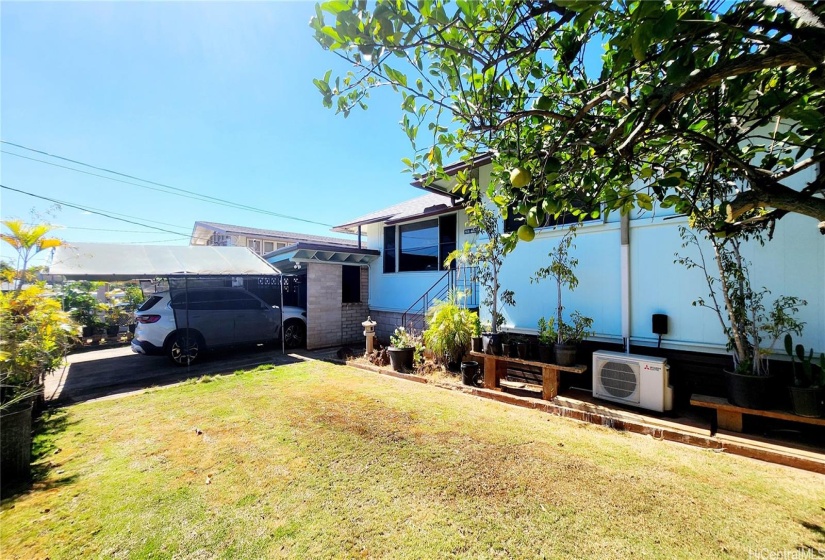 Front yard view with the view of the car port and driveway parking with shade