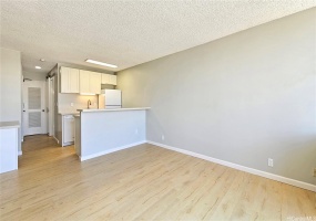 Living Room view towards new kitchen and built-in desk. Note: Walls have been refinished (smoothed).